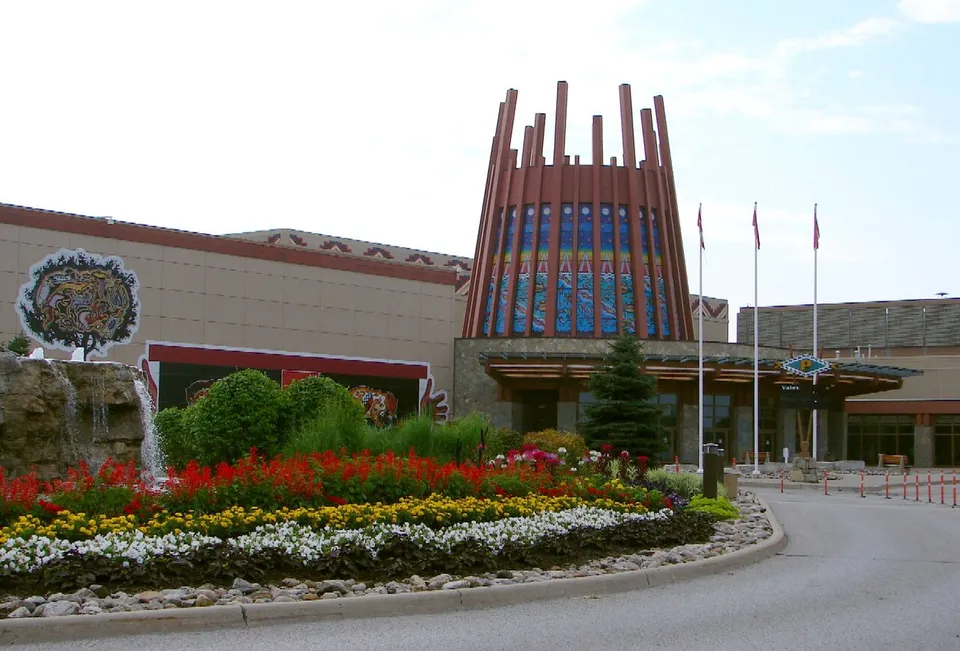 The entrance drive of Casino Rama with flower beds, flags and the tall slatted entrance feature, in July 2010.
